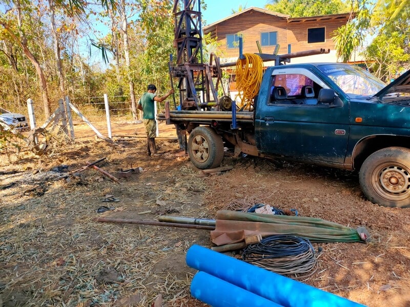 drilling for water, the drill is on the back of a truck 